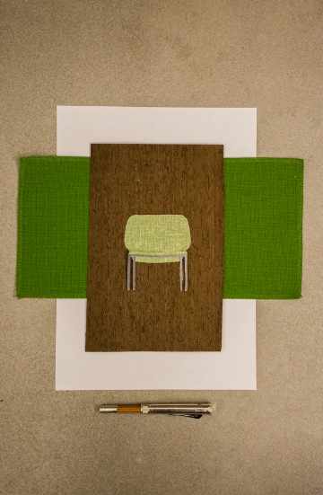 Low back upholstered lounge chair with soft curves and compact proportions