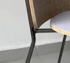 Contemporary upholstered chair with geometric backrest and elegant metal frame designed for comfort and versatility