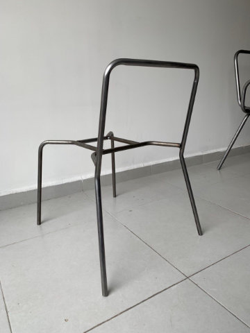 Contemporary upholstered chair with geometric backrest and elegant metal frame designed for comfort and versatility