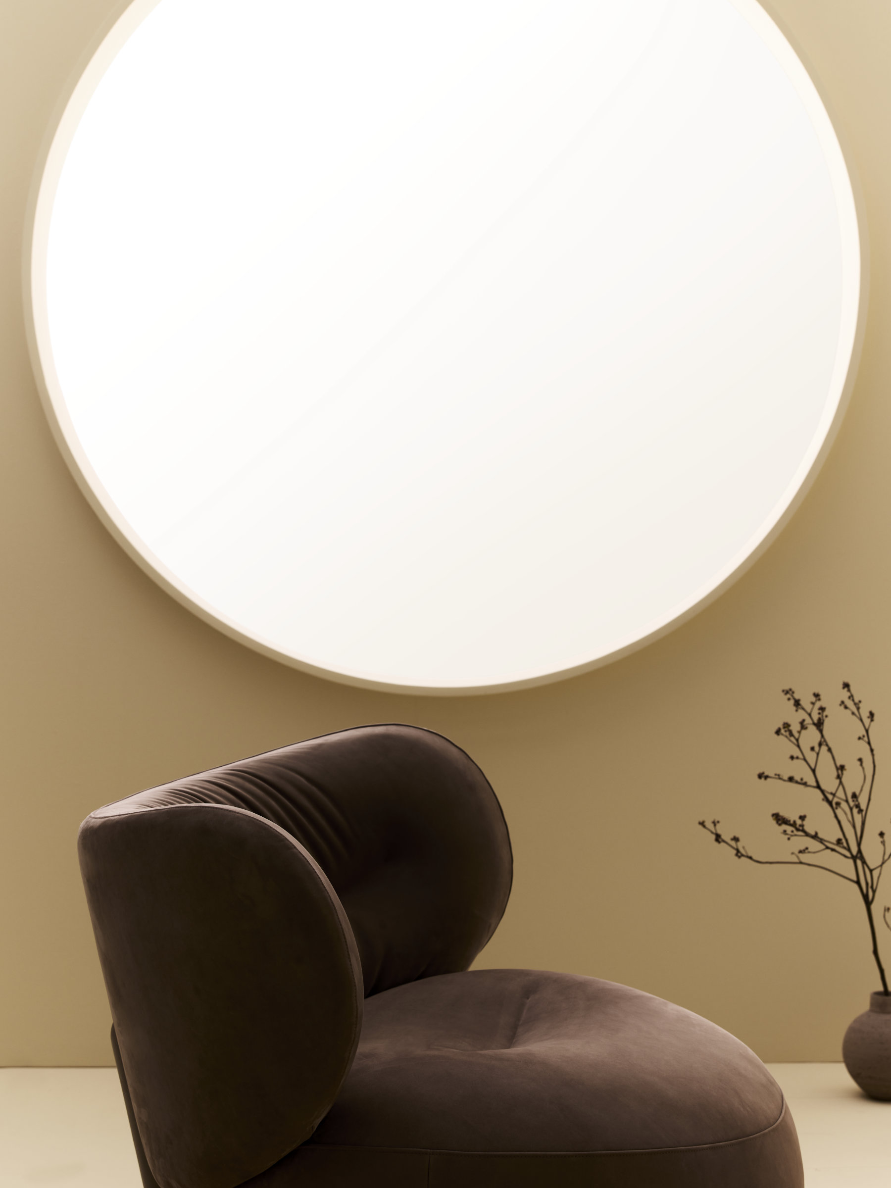 Amelie armchair in a relaxed interior setting highlighting its sculptural presence.