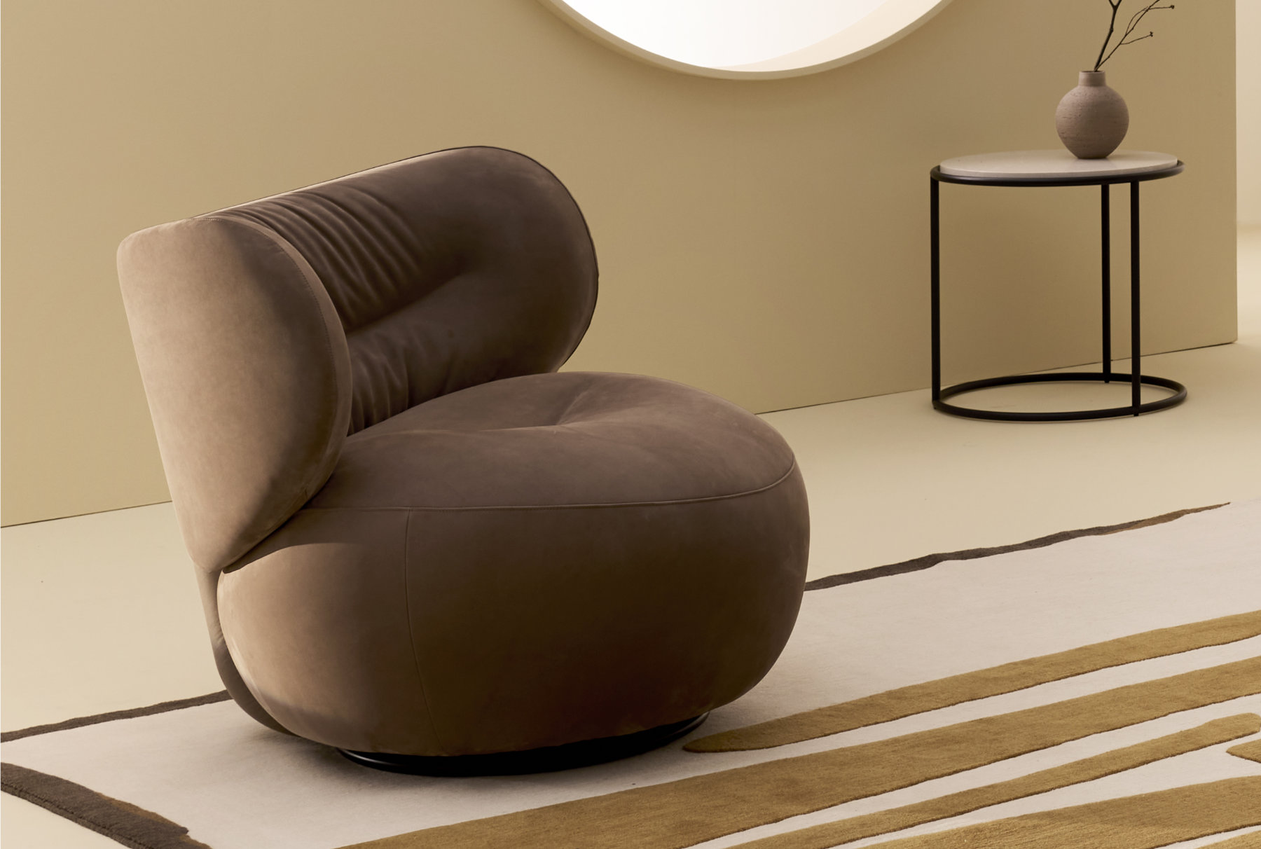 Amelie armchair in a relaxed interior setting highlighting its sculptural presence.