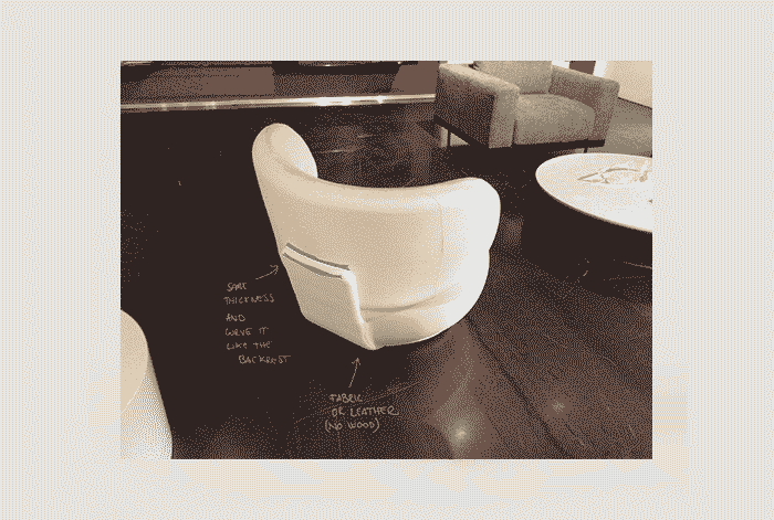 Amelie armchair in a relaxed interior setting highlighting its sculptural presence.