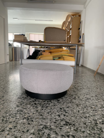 Brisa modular poufs arranged in a curved lounge configuration