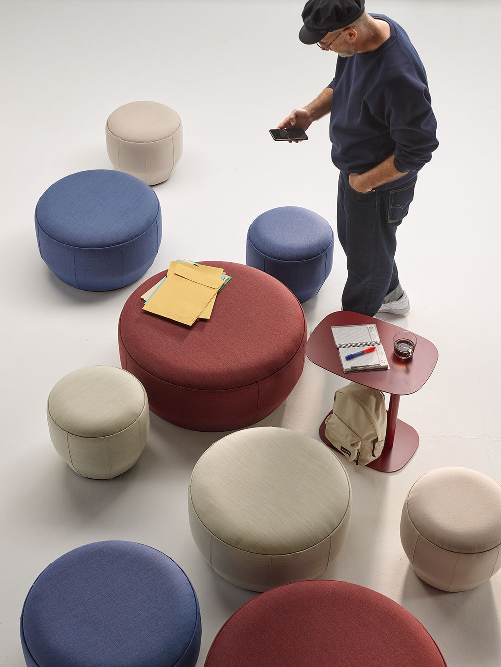 Brisa modular poufs arranged in a curved lounge configuration