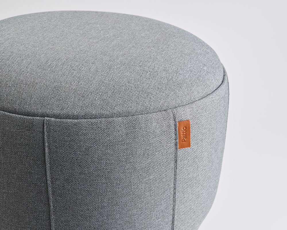 Brisa modular poufs arranged in a curved lounge configuration