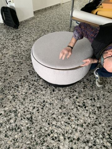 Brisa modular poufs arranged in a curved lounge configuration