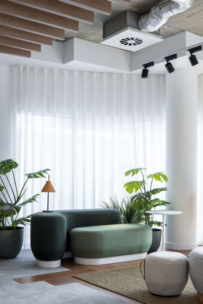 Brisa modular poufs arranged in a curved lounge configuration