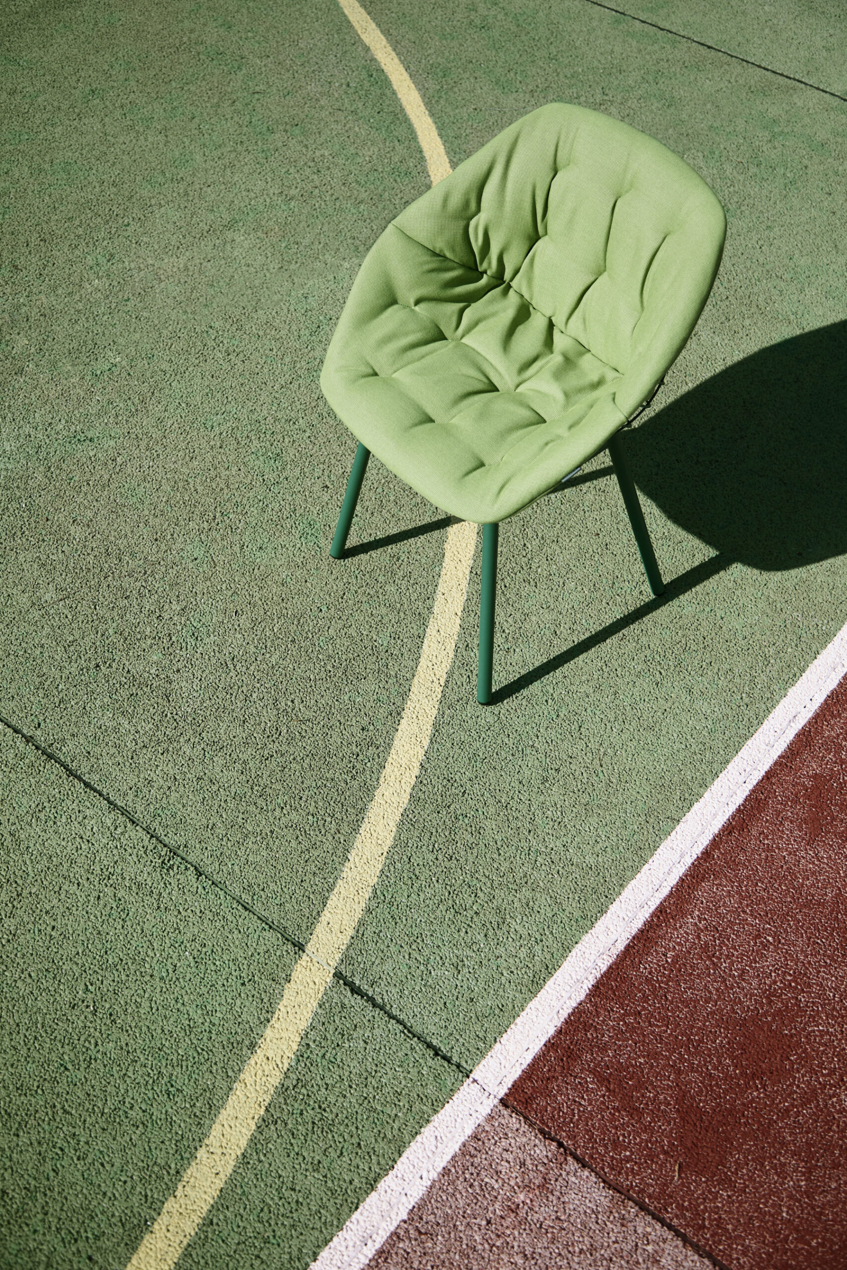 Canasta outdoor chair with woven wire shell in terrace setting