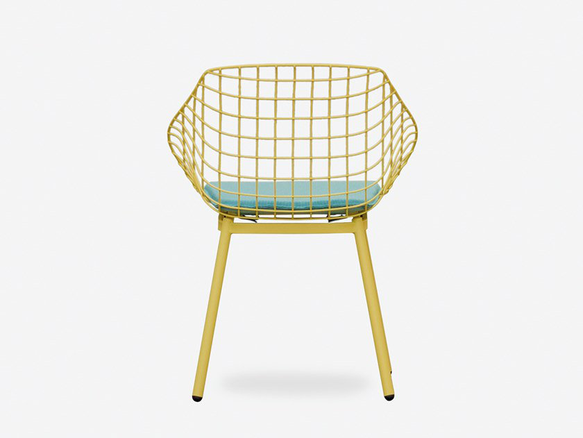 Canasta outdoor chair with woven wire shell in terrace setting