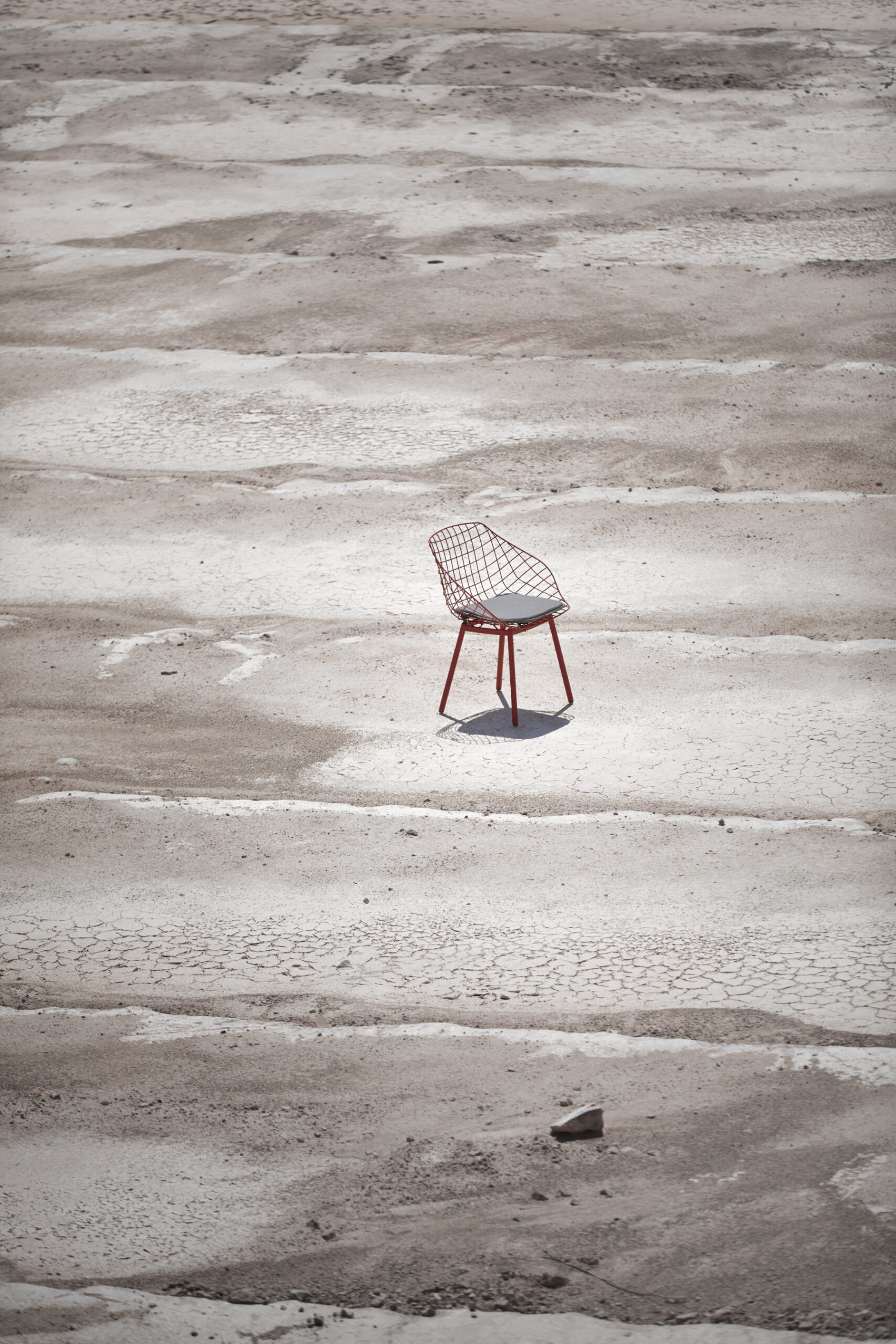 Canasta outdoor chair with woven wire shell in terrace setting