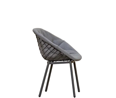 Canasta outdoor chair with woven wire shell in terrace setting