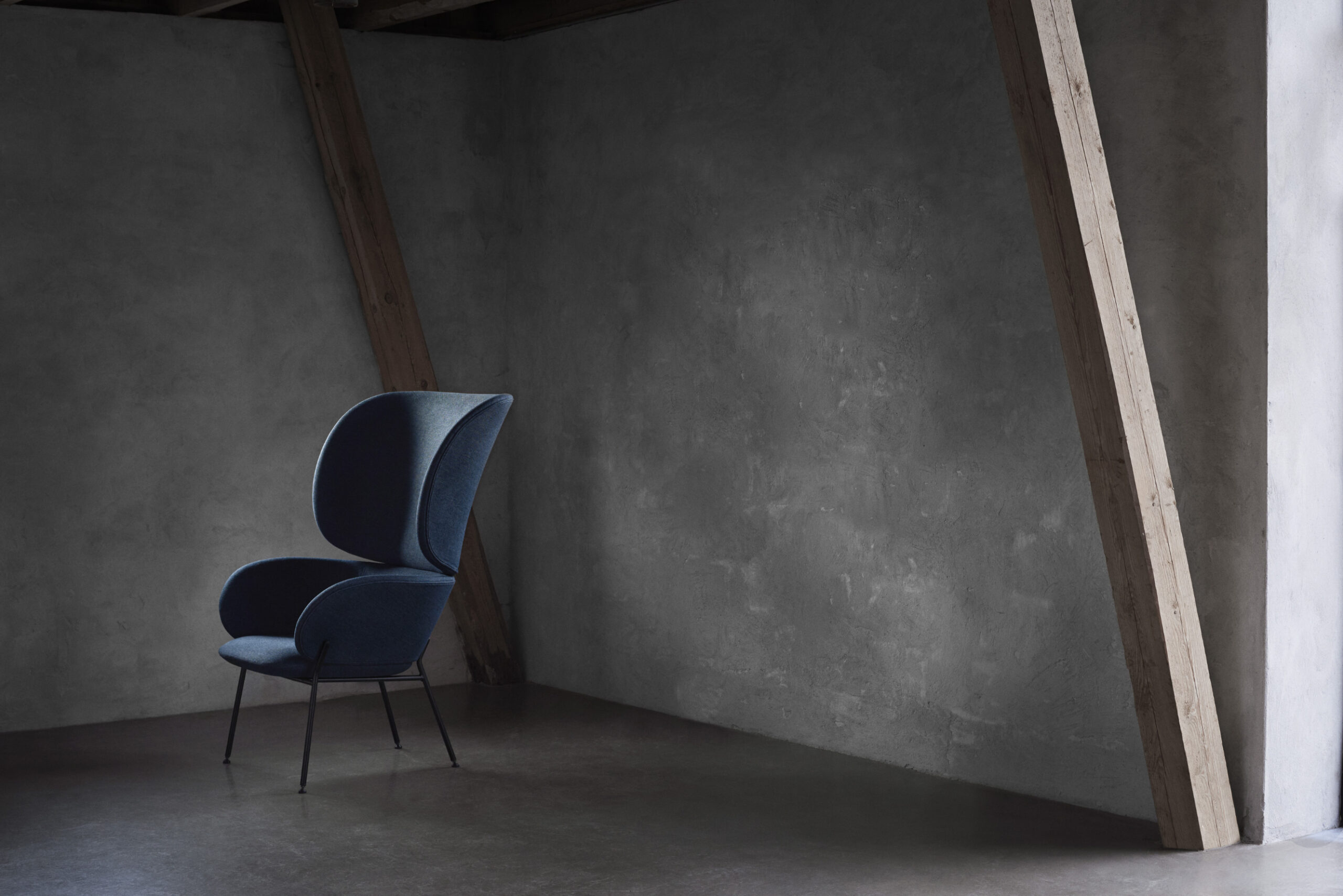 Carmen armchair in contemporary interior showing refined silhouette and tactile upholstery