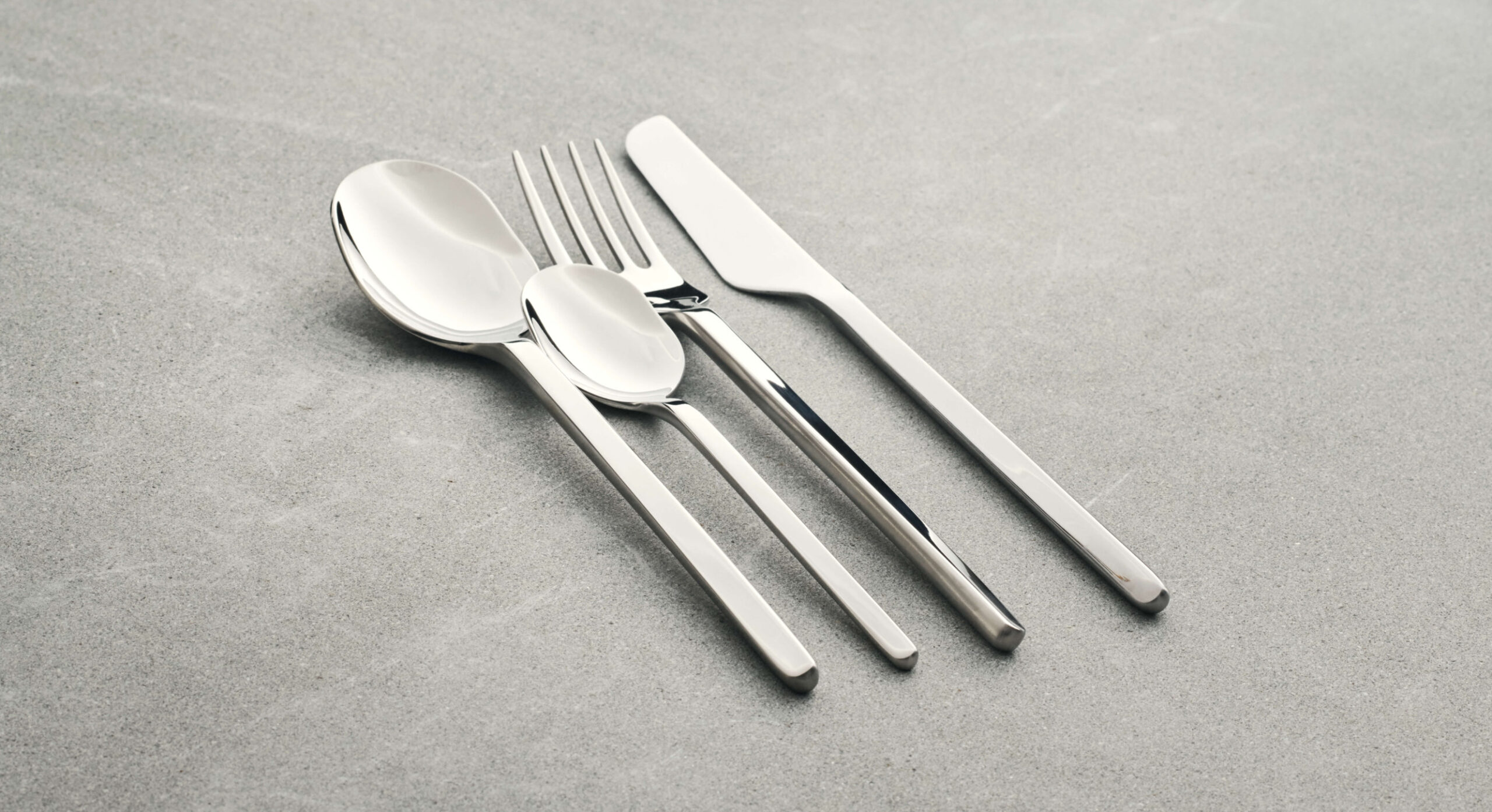 Carved cutlery set on a minimalist dining table