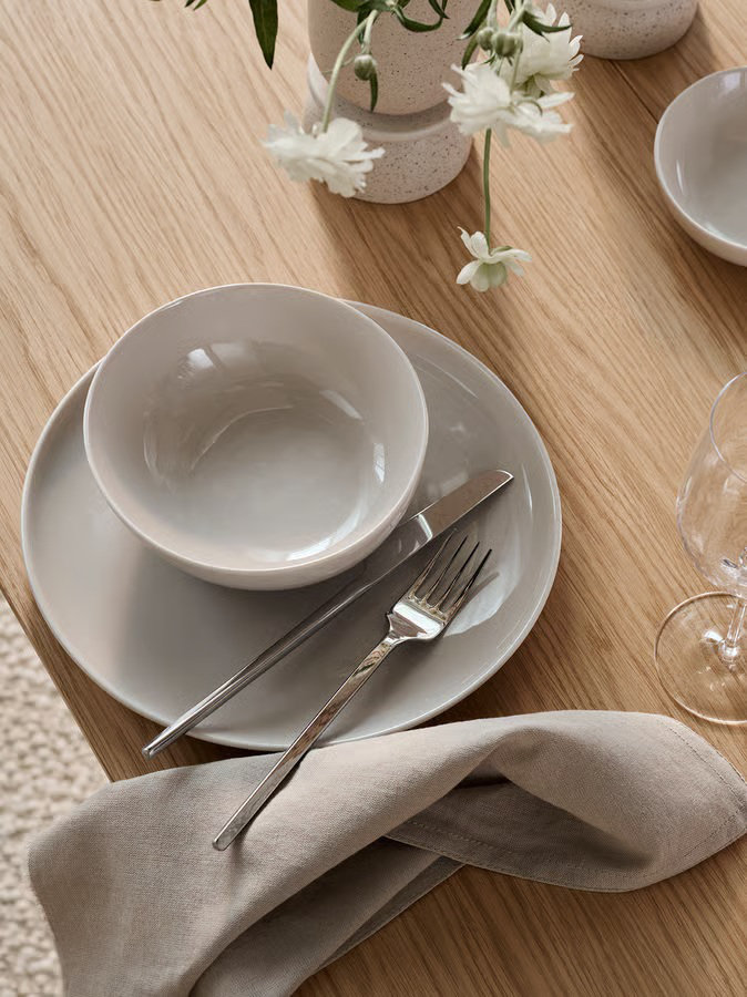 Carved cutlery set on a minimalist dining table