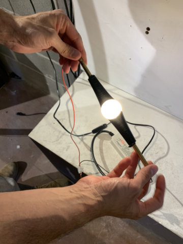 Dew lamp with softly glowing body in modern interior