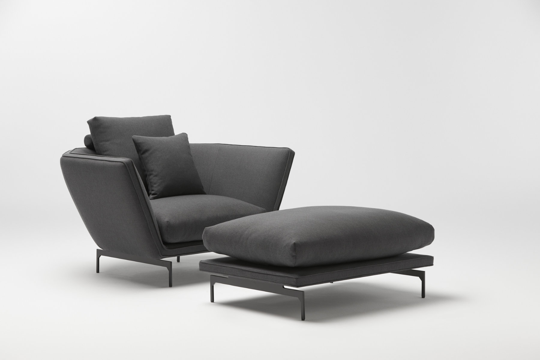 Disc sofa with curved backrest in contemporary lounge setting