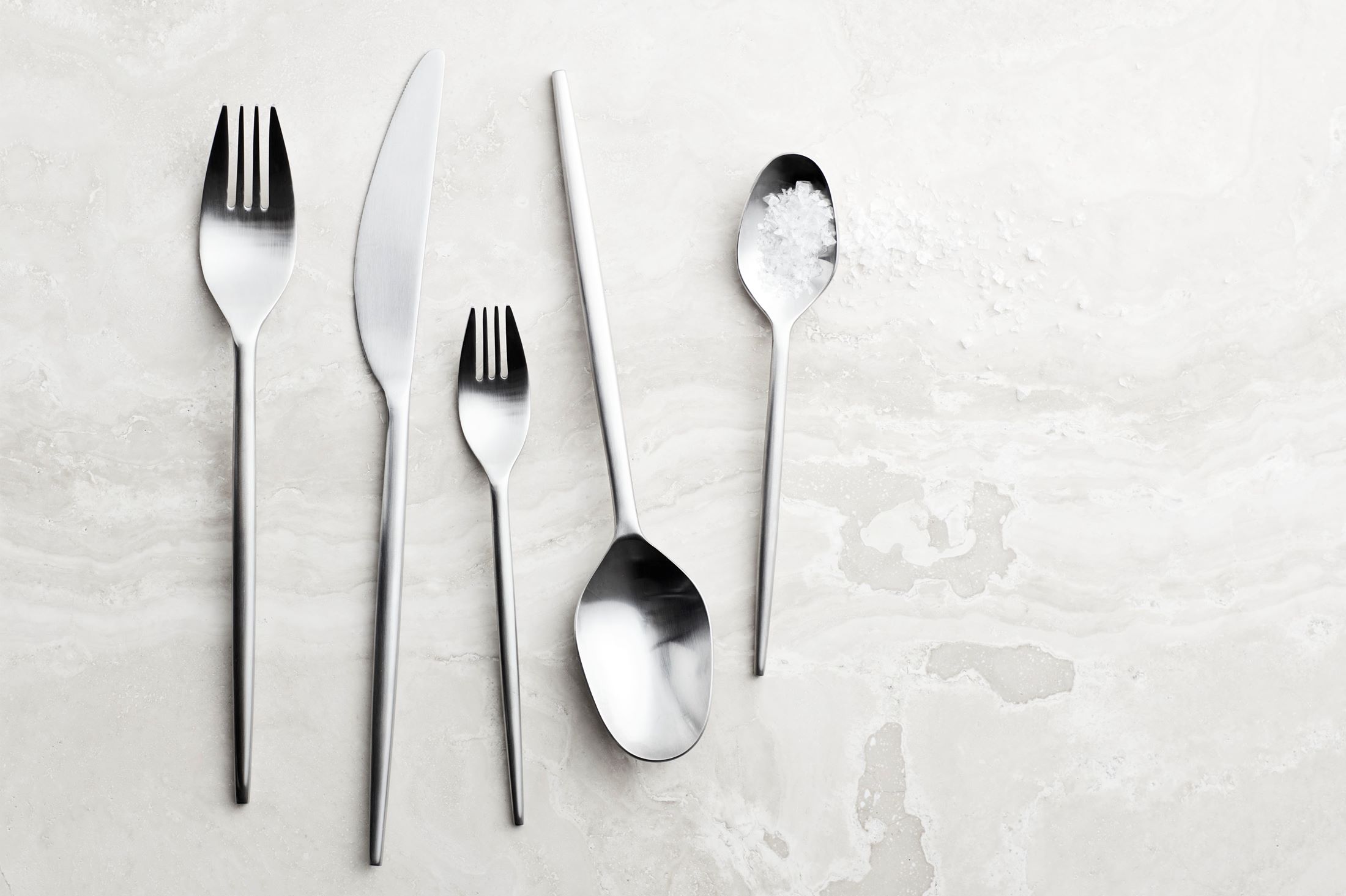Elegant contemporary cutlery set with fluid contours and refined proportions