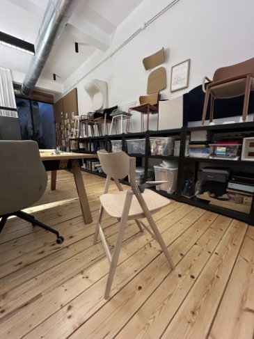 Elegant wooden folding chair with integrated handles born from memory and ergonomics