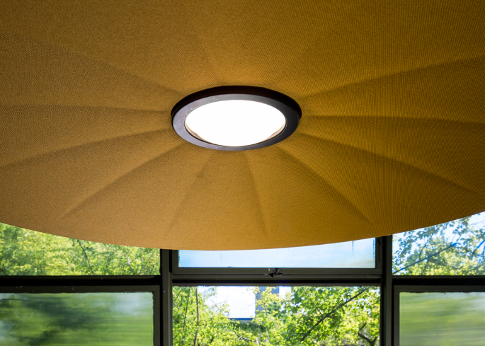 Lent acoustic lamp in contemporary interior with soft lighting and sound-absorbing surface