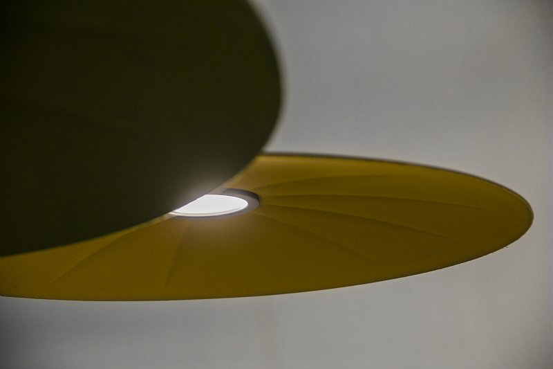 Lent acoustic lamp in contemporary interior with soft lighting and sound-absorbing surface