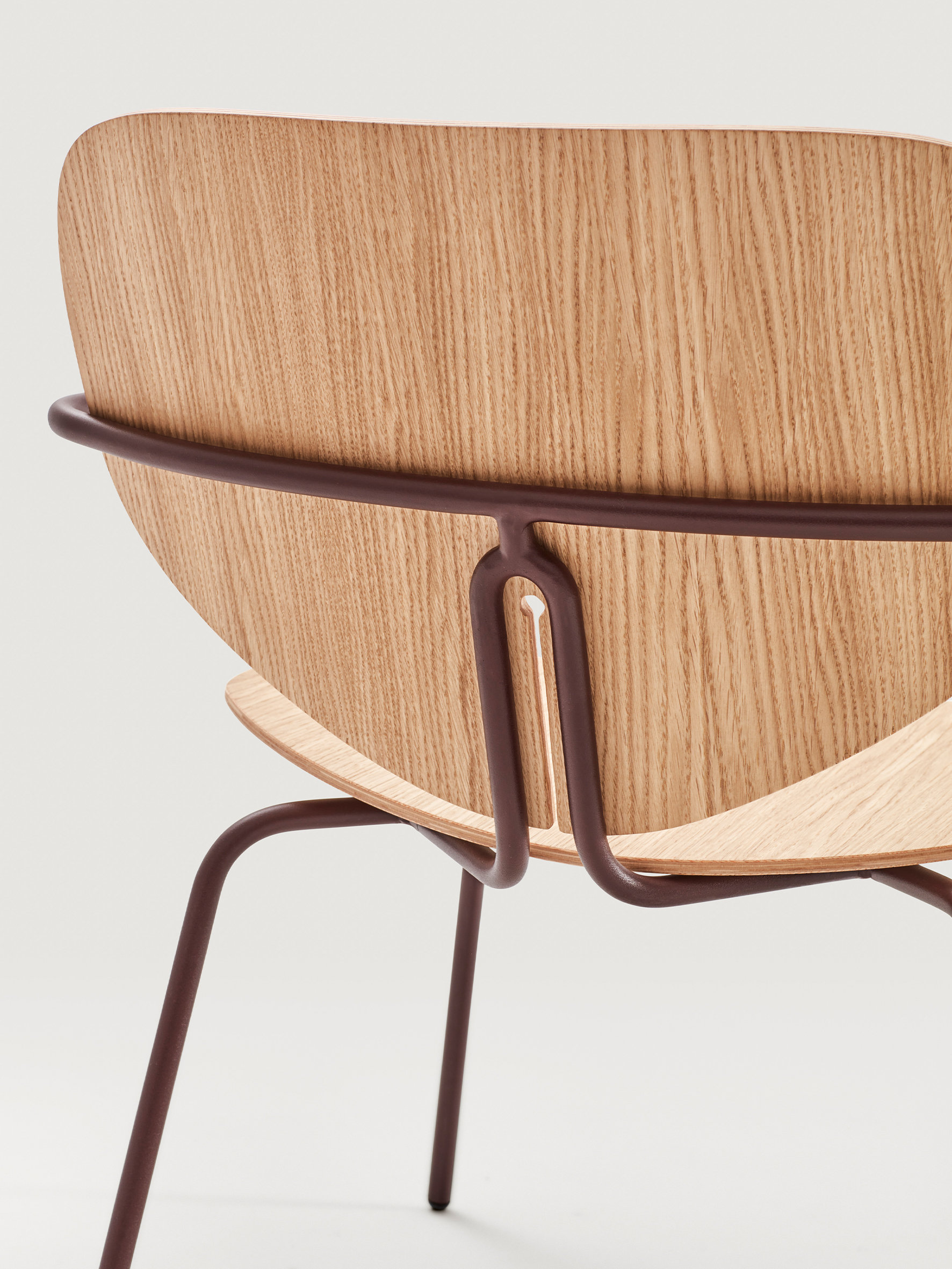 Contemporary upholstered chair with rounded organic silhouette inspired by the soft curves of a ladybird