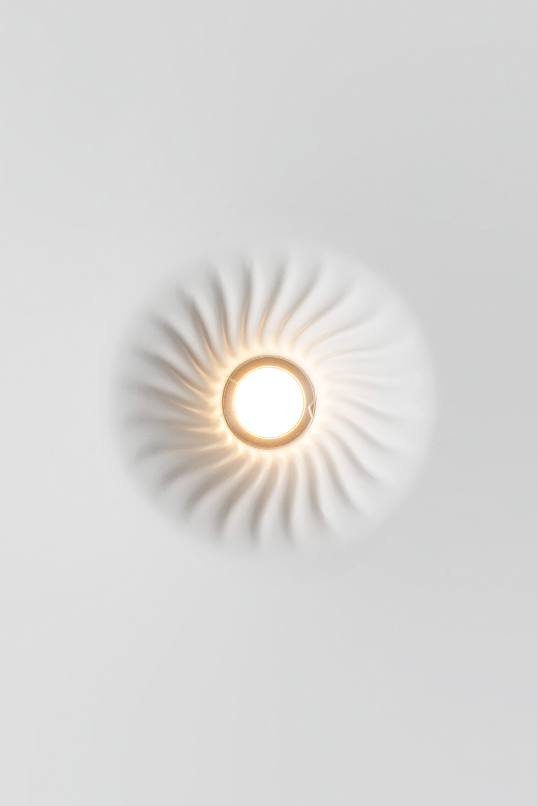 Mediterranean Collection ceiling luminaire in Crismosil featuring radial textured surface and warm integrated LED light