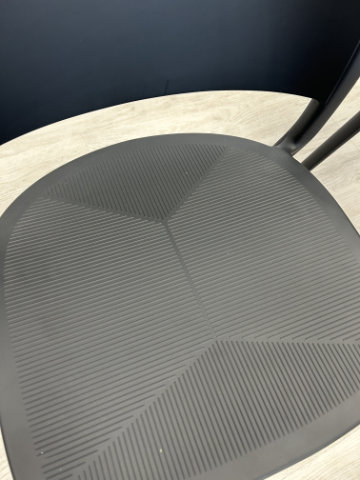 Contemporary chair with fluid silhouette and continuous curves balancing comfort and refined proportion