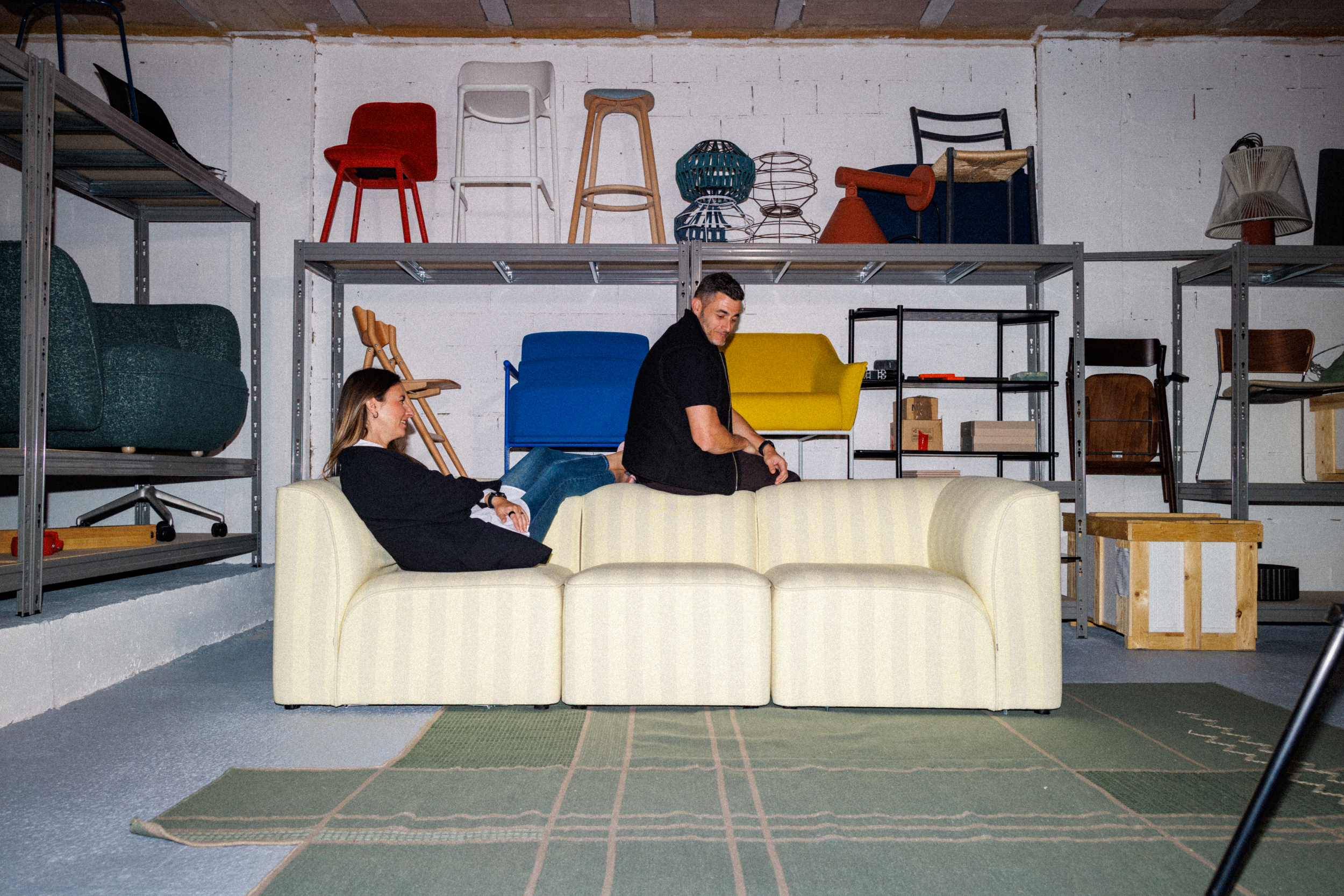 yonoh team (clara and alex) seating on the flora sofa system designed for woud in the Yonoh archive studio