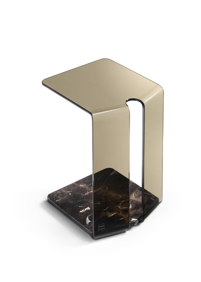 York glass side table with slender structural frame in contemporary interior