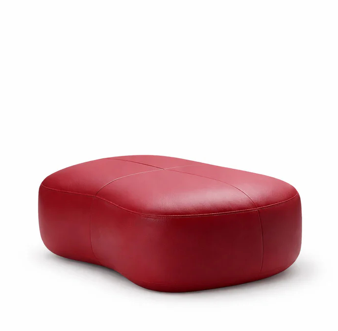 Upholstered lounge chair with circular base and segmented padded backrest, soft sculptural design.